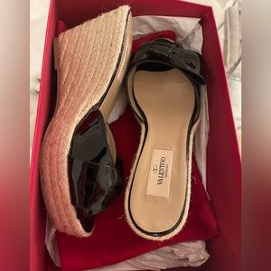 New Valentino Garavani Black Patent leather wedge slides with bow detail.